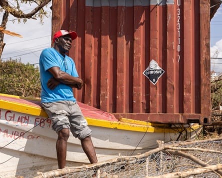 Fisher Allan Daley sits on his damaged boat