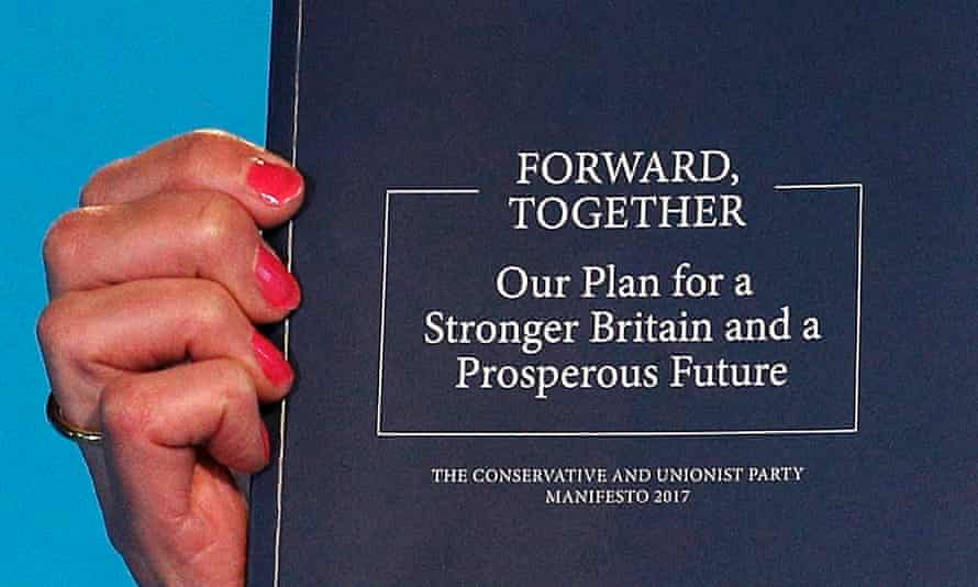 Theresa May holds up the Conservative manifesto at its launch.