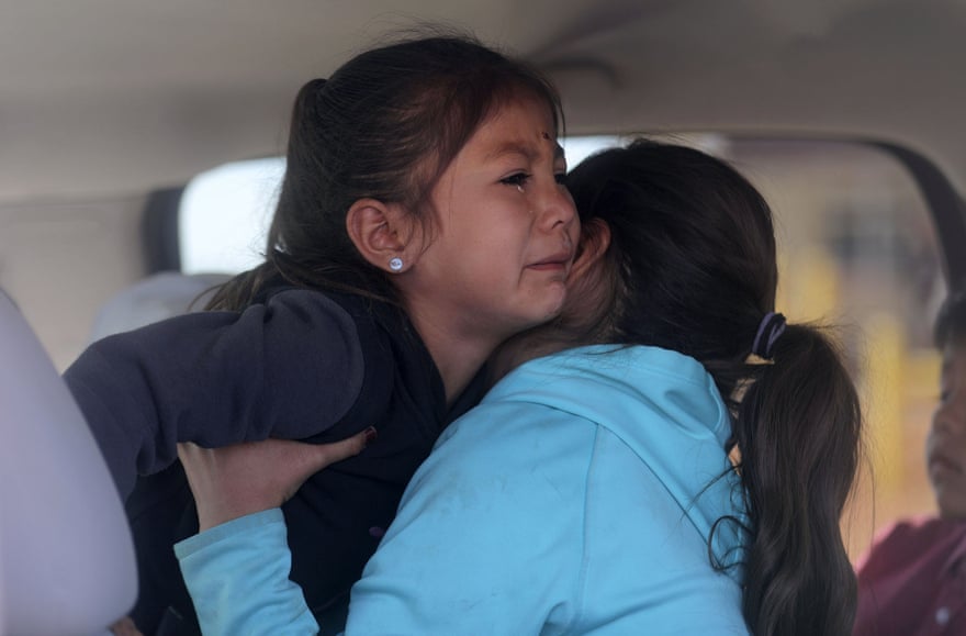 Sophie Hunt gets a hug from her sister after Sophie’s Covid-19 test in their grandparents’ truck, outside of the Monument Valley Health Center in Oljato-Monument Valley in Utah.