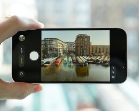 The camera app on an iPhone 17e taking a photo of houseboats on Regent’s Canal.