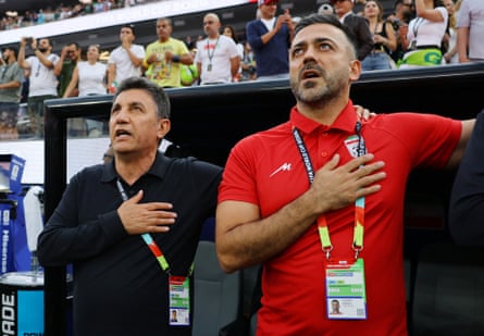 Iran coach Amir Ghalenoei and assistant coach Saeed Alhoei during the national anthems before the match against Egypt