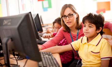 A teacher and pupil using a computer