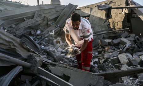 A man searches through buildings destroyed during Israeli air raids in the southern Gaza Strip.
