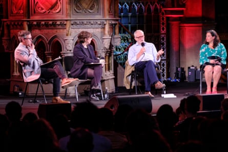 four people seated on a stage
