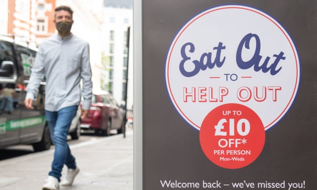 Man walking past an 'Eat Out to Help Out' scheme