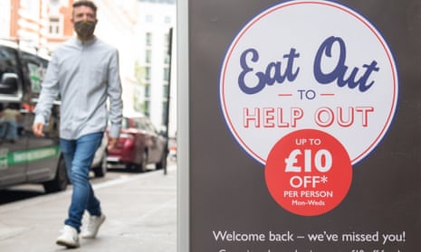 A man passing a sign advertising the ‘eat out to help out’ scheme