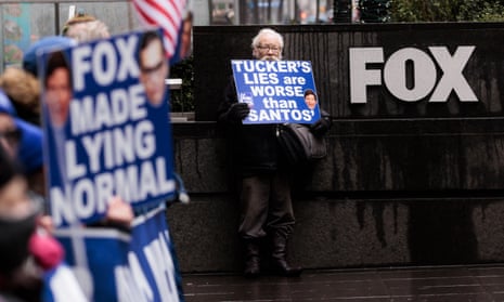 People participate in a protest outside of Fox News headquarters in New York on 28 February 2023.