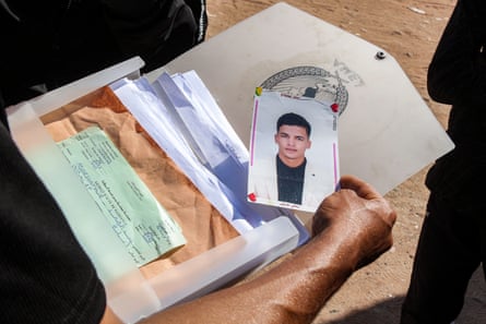 A folder with documents and a photograph of a young man