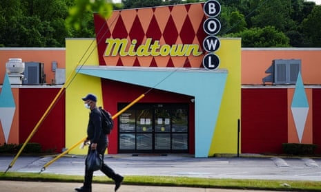 A man walks past the Midtown Bowl bowling alley in Atlanta, Georgia, on Tuesday. Bowling alleys are among businesses the governor, Brian Kemp, has said can reopen on Friday.
