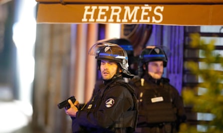 French police stand outside a branch of Hermès on the Champs Élysées