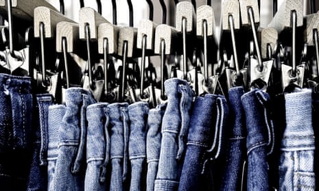 blue jeans hanging on a rack