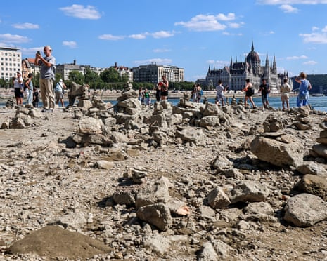 People explore the exposed riverbed of the Danube River in Budapest, Hungary.