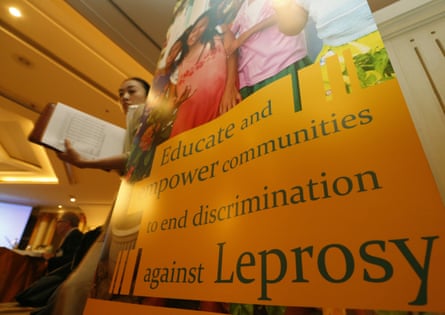 sign says 'educate and empower communities to end discrimination against leprosy'