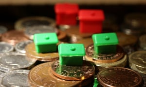 Monopoly houses and hotels sit atop penny coins