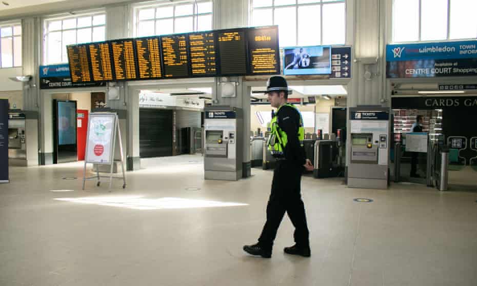 A British Transport Police officer at Wimbledon station in London on Monday as Britain slowly gets back to work.