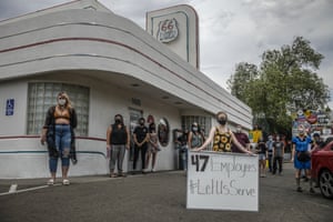 Some of the workers at Route 66 Diner in Albuquerque, New Mexico, gather outside the restaurant during a protest against the governor’s order that restaurants shut down.