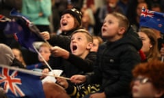 Team New Zealand supporters celebrate as they watch the racing at the Royal New Zealand Yacht Squadron.
