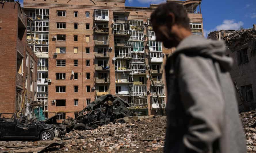 A man walks past heavily damaged buildings and destroyed cars in Bakhmut, Donetsk region, eastern Ukraine.