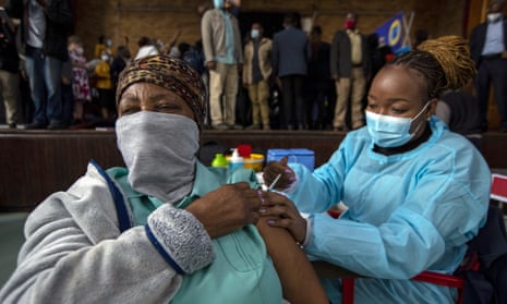 A healthcare worker gives a Covid jab to a woman in Katlehong, South Africa