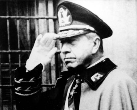 A black-and-white photo of a man wearing a military uniform in salute