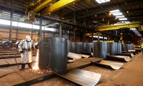 An employee cutting a sample from a roll of coiled steel inside Liberty House Group’s rolling steel mill in Newport.
