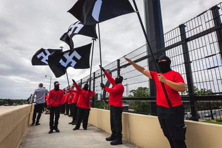 Neo-Nazis Sieg heiling with swastika flags.