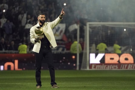 Former Lyon player Karim Benzema holds his Ballon d’Or trophy at the club’s Ligue 1 game against Nice on Friday night.