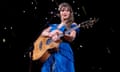 Taylor Swift on stage with guitar
