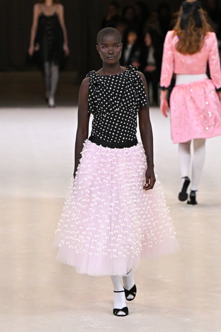  Model wears pink tutu-style skirt with sleeveless black polkadot top 