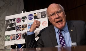 With examples of Russian-created Facebook pages behind him, Senator Patrick Leahy speaks on Capitol Hill.