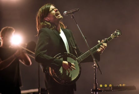 Winston Marshall performing on stage.