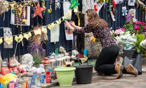 Tributes are left at the foot of Grenfell Tower.