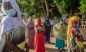 Voters queue at a primary school in Cotonou to cast their vote in Benin's local elections.