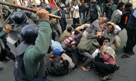 Riot policemen charge a group of activists in  Dhaka, Bangladesh.