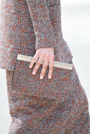A tweed suit with matching clutch bag.