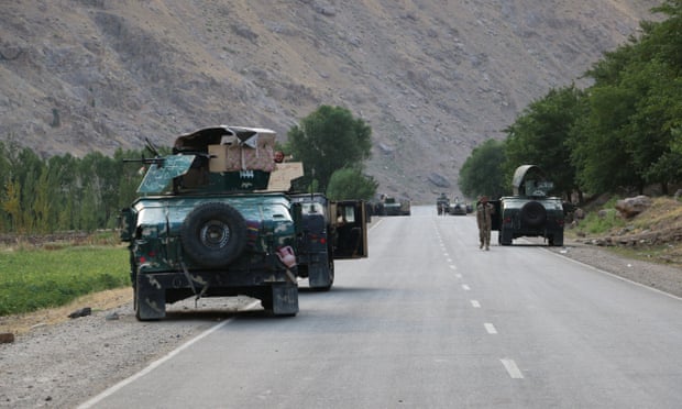 Afghan soldiers on a road at the frontline of fighting with the Taliban near the city of Badakhshan
