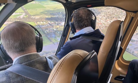 Daniel Andrews and Anthony Albanese look out of a helicopter windscreen