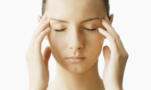 Woman with fingers on temples