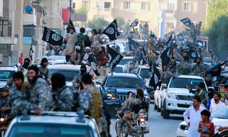 Show of force: Isis members parade through the streets of Raqqa, 2014. 