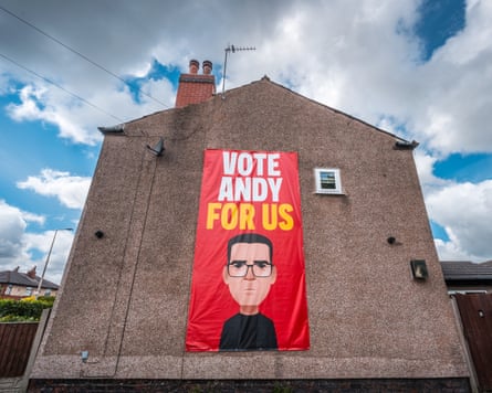 A banner declaring ‘Vote Andy For Us’ depicting Andy Burnham adorns the side of a home in Ashton-in-Makerfield, England