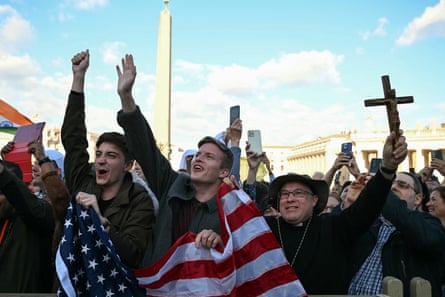 People gathered in St Peter’s Square in Vatican City celebrate after white smoke rose from the chimney of the Sistine Chapel.