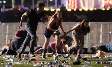 People run from the Route 91 Harvest country music festival after gunfire is heard on October 1 2017 in Las Vegas, Nevada.
