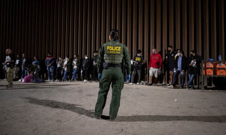 Hundreds of migrants cross the US-Mexico border in Yumaepa10026783 A US Border Patrol officer looks at migrants lining up against ‘the wall’ before processing them as hundreds cross the border between Mexico and the US in Yuma, Arizona, USA, 20 June 2022 (issued 21 June 2022). Coming from all over the world, most of the migrants who cross the border where the wall ends at the limit of the Cocopah Indian Reservation, willingly turn themselves to US Border Patrol officers who will process them as they ask for asylum. EPA/ETIENNE LAURENT ATTENTION: This Image is part of a PHOTO SET