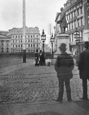 black and white photo of men walking in city