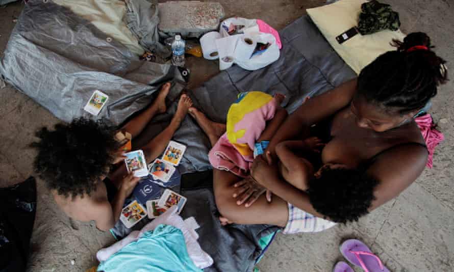 An asylum-seeking migrant, who was apprehended and returned to Mexico under Title 42 after crossing the border into the US, is pictured with her daughters in a public square where hundreds of migrants live in tents, in Reynosa, Mexico, this month.