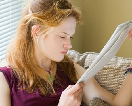 A young woman feeling stressed out with paperwork.