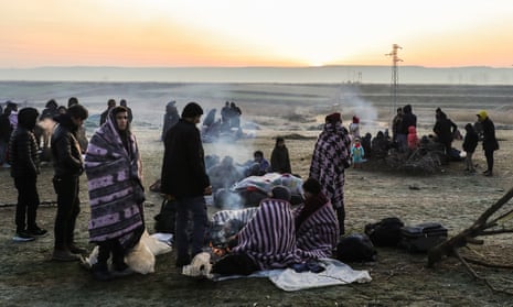 Refugees and migrants rest near Pazarkule border as they attempt to enter Greece from Turkey.