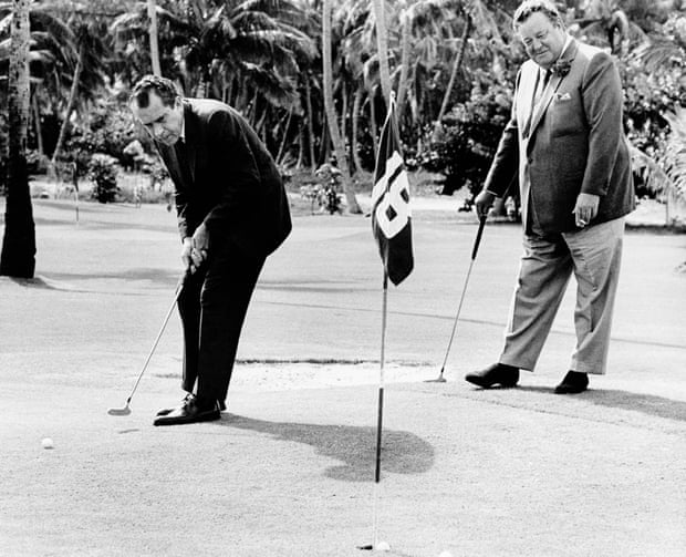 Richard Nixon sinks a putt with comedian Jackie Gleason in 1968.