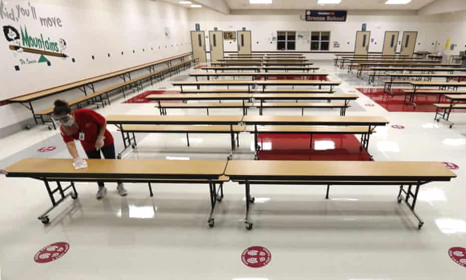 Tables are wiped down in the cafeteria at Stephens elementary school in Rowlett, Texas, on 22 July. 