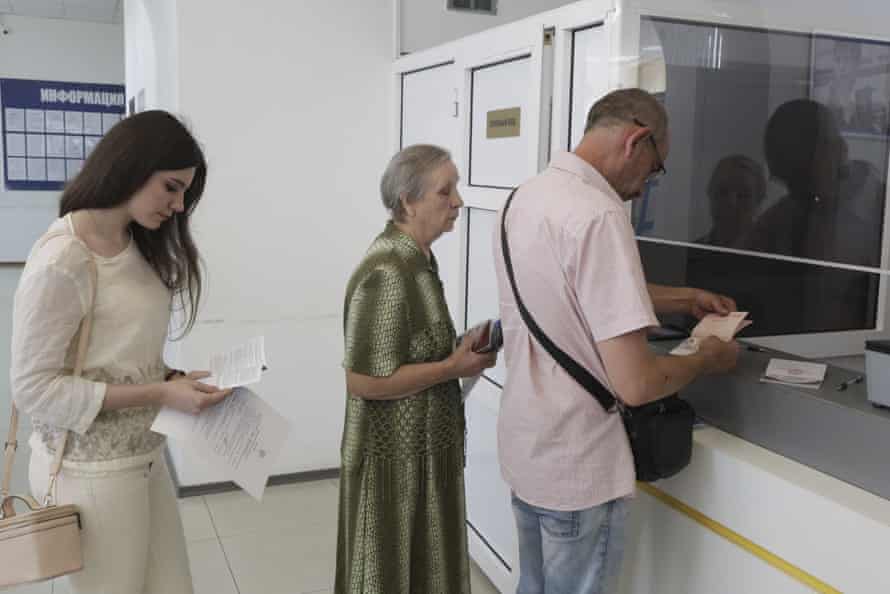 Residents of Donetsk stand in line at a migration service office to receive a passport of a citizen of the Russian Federation, in Donetsk, in an area controlled by Russian-backed separatist forces, eastern Ukraine.
